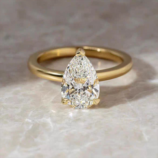 Drop - shaped diamond ring with a plain shank.