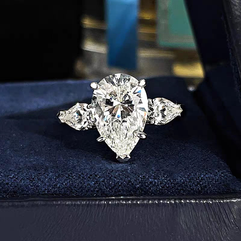 Drop - shaped three - stone diamond ring.